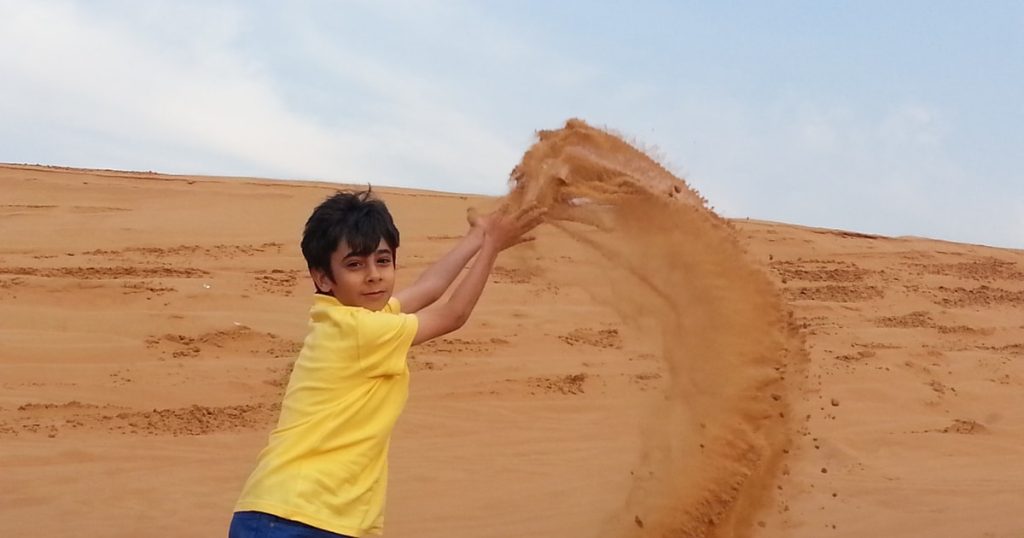 Family enjoying Dubai desert safari with kids