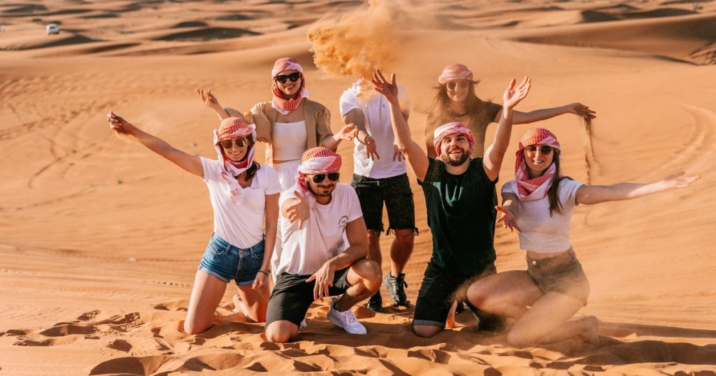 Kids sandboarding during Desert Safari in Dubai