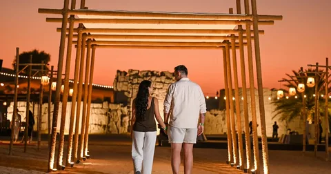 Romantic honeymoon desert safari Dubai with couple at sunset